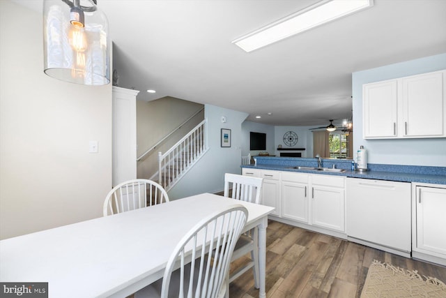 dining area featuring recessed lighting, a ceiling fan, stairs, and wood finished floors
