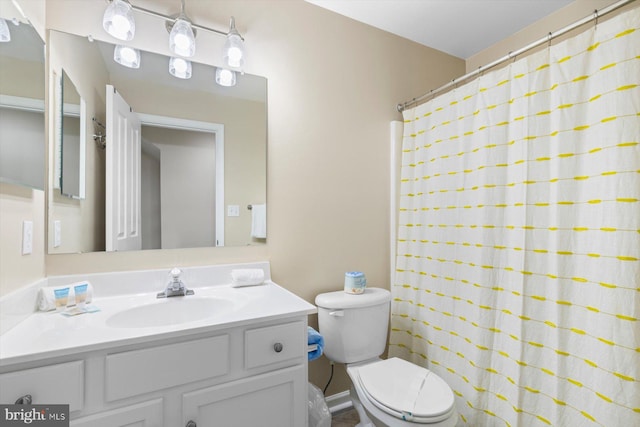 bathroom featuring vanity, a shower with curtain, and toilet