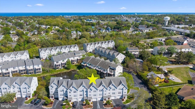 birds eye view of property with a water view and a residential view