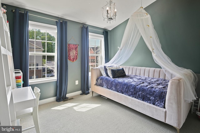 bedroom featuring an inviting chandelier, baseboards, multiple windows, and carpet flooring