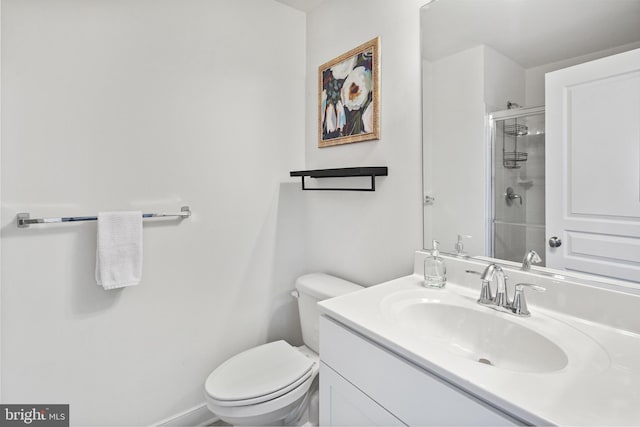 full bathroom with vanity, a stall shower, and toilet