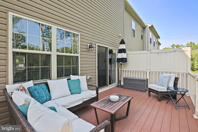 wooden terrace featuring an outdoor living space