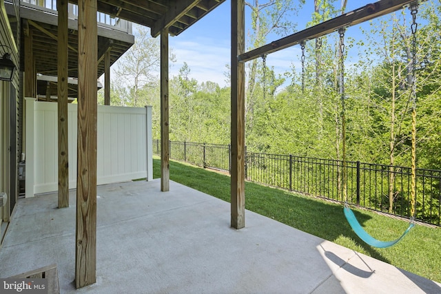 view of patio with a fenced backyard and a forest view