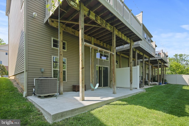 back of property with a patio, central AC unit, fence, and a yard