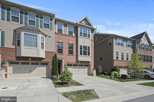 view of property featuring an attached garage, driveway, and brick siding