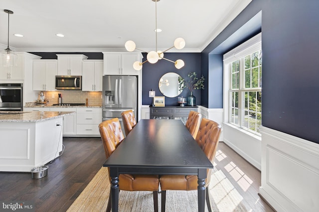 dining area featuring dark wood-type flooring, ornamental molding, and recessed lighting