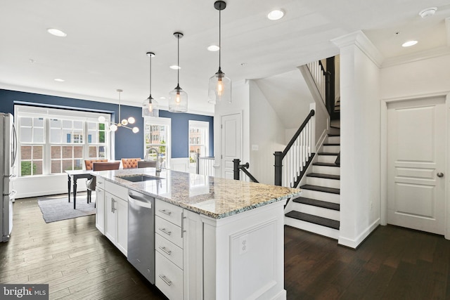 kitchen with a sink, white cabinets, dark wood-style floors, stainless steel appliances, and recessed lighting