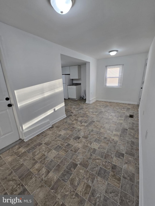 810 Mohn St, Harrisburg, PA 17113 - unfurnished room with visible vents, stone finish floor, and baseboards