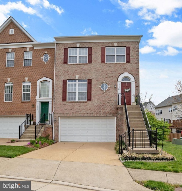 multi unit property with brick siding, an attached garage, and concrete driveway