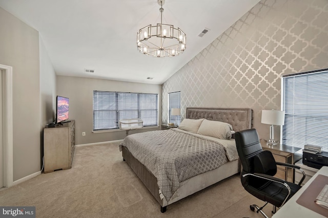bedroom with an inviting chandelier, an accent wall, visible vents, and baseboards