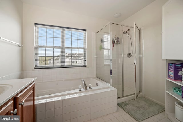 bathroom featuring a bath, a shower stall, tile patterned floors, and vanity