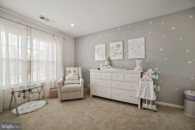 living area featuring visible vents, baseboards, and light carpet