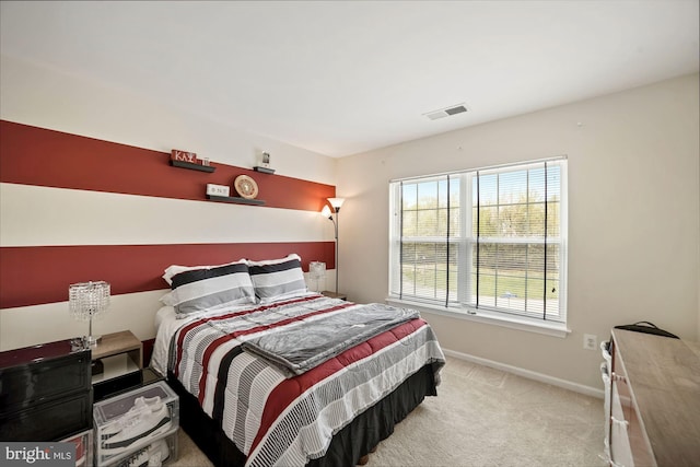 carpeted bedroom featuring baseboards and visible vents