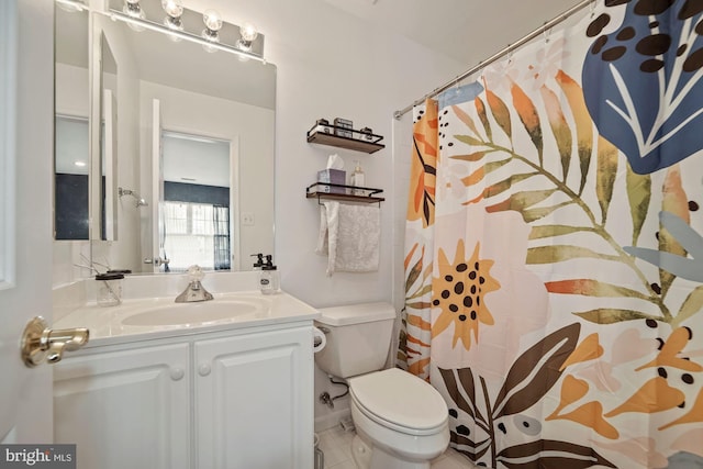bathroom with a shower with curtain, toilet, vanity, and tile patterned floors