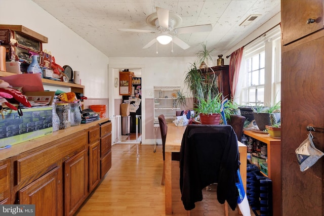 dining area with ceiling fan, visible vents, and light wood-style flooring