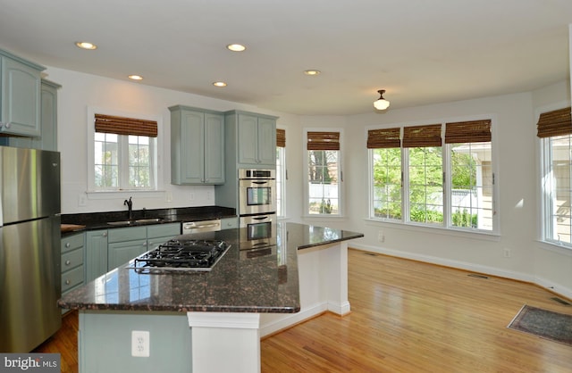 kitchen featuring recessed lighting, appliances with stainless steel finishes, baseboards, and a sink