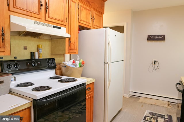 kitchen with range with electric stovetop, under cabinet range hood, light countertops, a baseboard heating unit, and freestanding refrigerator