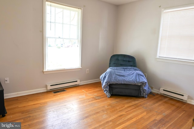 sitting room with a healthy amount of sunlight and baseboard heating