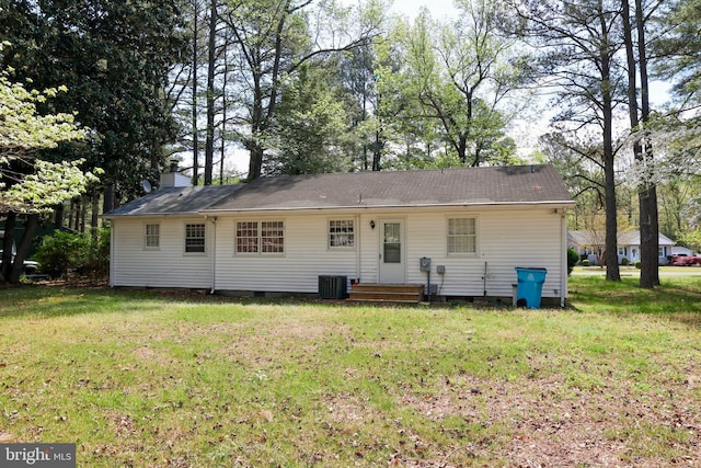 back of property featuring crawl space, a yard, and central AC unit