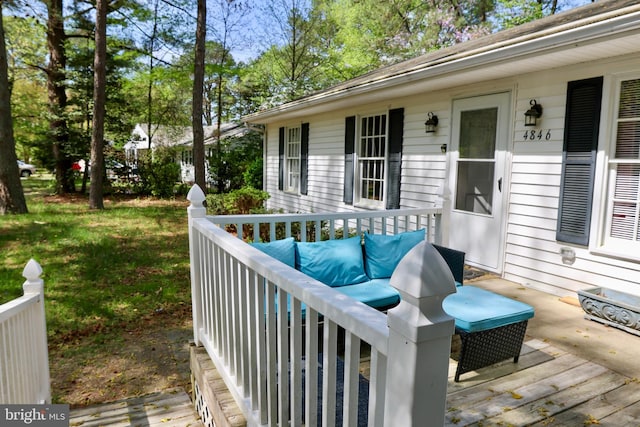 wooden terrace featuring an outdoor hangout area