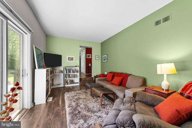 living room featuring visible vents and wood finished floors