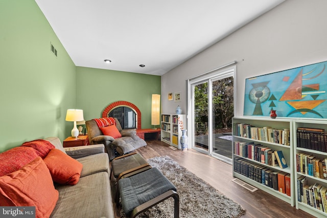 living area with visible vents and wood finished floors