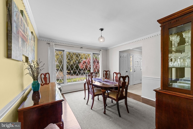 dining room featuring wood finished floors and ornamental molding