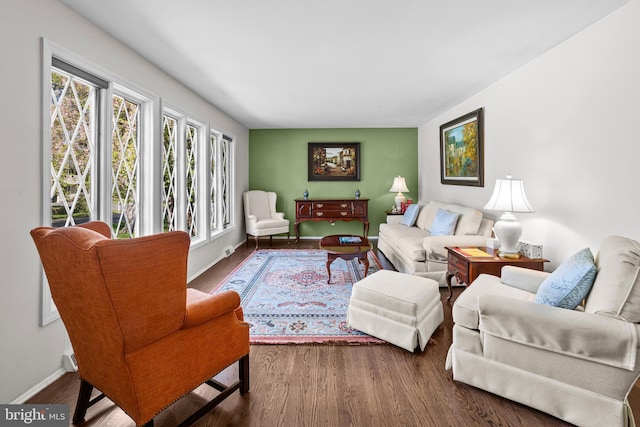 living area with wood finished floors and baseboards