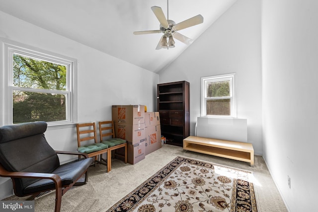 sitting room with carpet, a healthy amount of sunlight, ceiling fan, and high vaulted ceiling