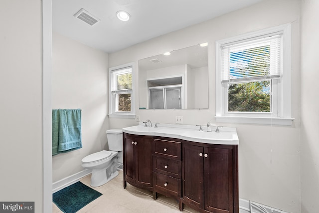 full bath featuring visible vents, toilet, a stall shower, and a sink