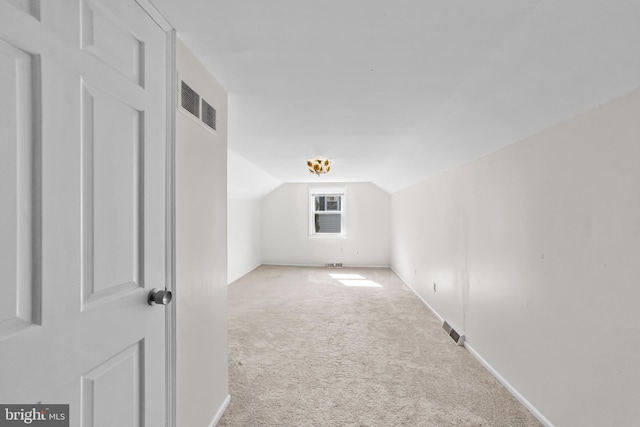bonus room featuring baseboards, visible vents, carpet, and vaulted ceiling