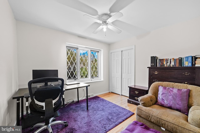 home office with wood finished floors, ceiling fan, visible vents, and baseboards