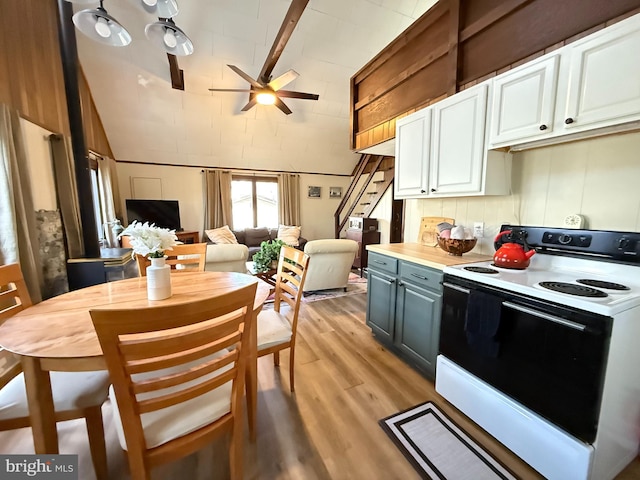 437 Orono Dr, Pocono Lake, PA 18347 - kitchen featuring ceiling fan, white range with electric cooktop, light wood-type flooring, lofted ceiling with beams, and white cabinetry