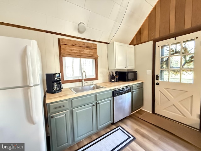 437 Orono Dr, Pocono Lake, PA 18347 - kitchen with stainless steel dishwasher, freestanding refrigerator, wood finished floors, light countertops, and a sink