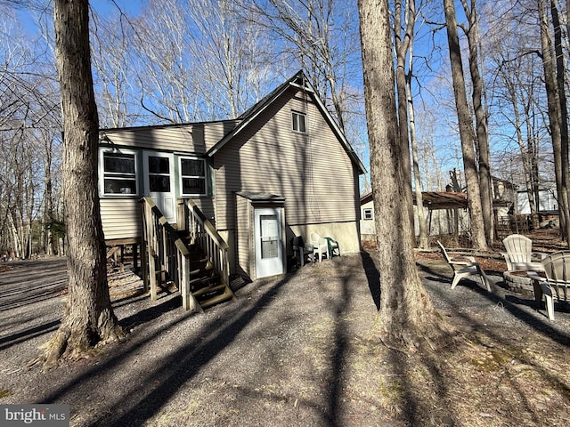 437 Orono Dr, Pocono Lake, PA 18347 - view of property exterior with an outdoor fire pit