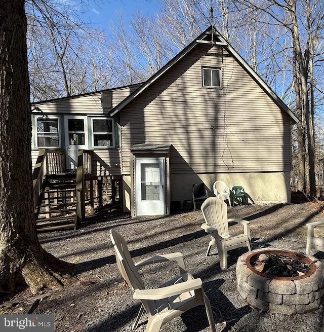 437 Orono Dr, Pocono Lake, PA 18347 - back of property with an outdoor fire pit