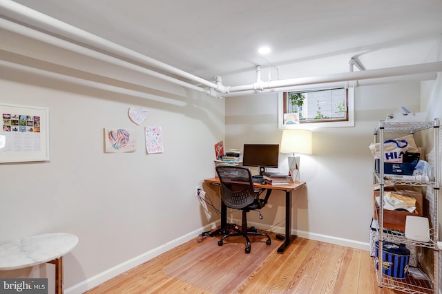 office space with baseboards and wood finished floors