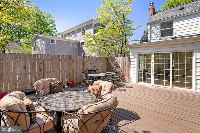 wooden deck with fence and outdoor dining space
