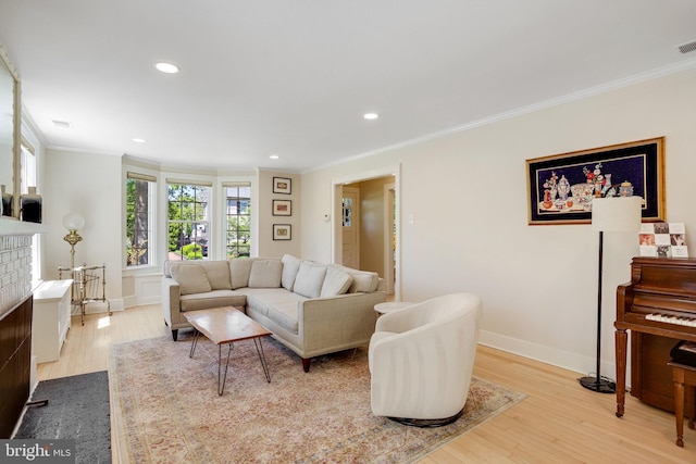 living area with crown molding, recessed lighting, baseboards, and wood finished floors