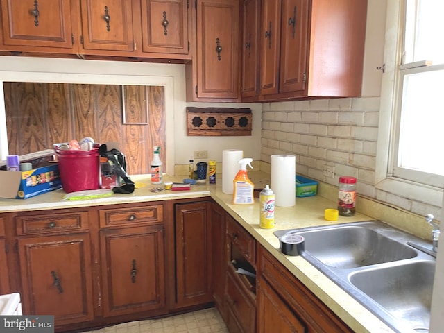 5781 N Timber Ridge Rd, Berkeley Springs, WV 25411 - kitchen with a sink, tasteful backsplash, brown cabinetry, and light countertops