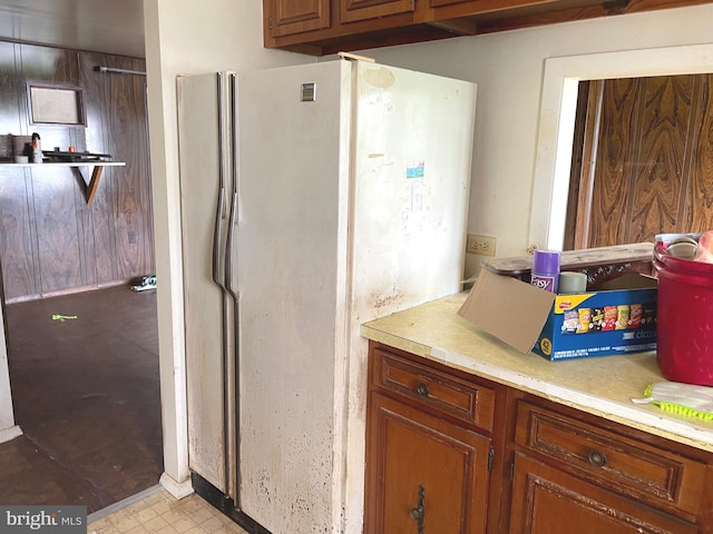 5781 N Timber Ridge Rd, Berkeley Springs, WV 25411 - kitchen featuring light floors, brown cabinetry, light countertops, and freestanding refrigerator