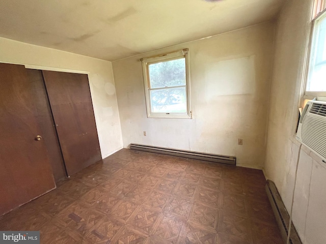 5781 N Timber Ridge Rd, Berkeley Springs, WV 25411 - unfurnished bedroom featuring a baseboard radiator, a closet, and multiple windows