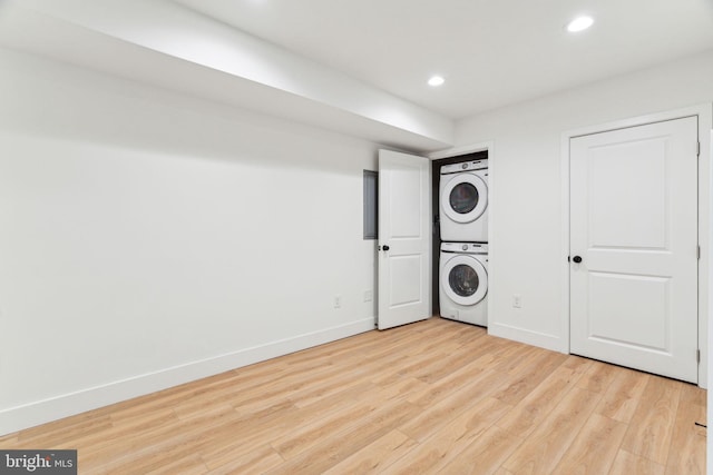 1810 Federal St Unit 1, Philadelphia, PA 19146 - washroom featuring stacked washing machine and dryer, recessed lighting, light wood-style flooring, and baseboards