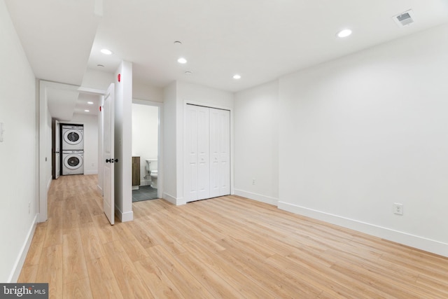 1810 Federal St Unit 1, Philadelphia, PA 19146 - unfurnished bedroom featuring estacked washer and dryer, light wood-type flooring, recessed lighting, and baseboards