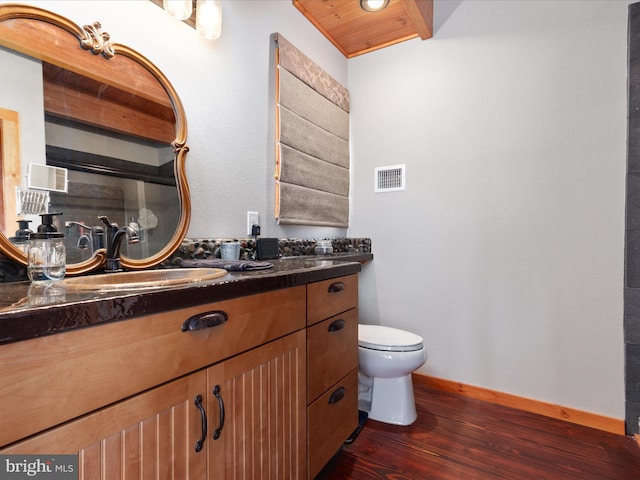 4437 Stonewall Jackson Hwy, Bentonville, VA 22610 - bathroom with wood finished floors, vanity, baseboards, toilet, and visible vents