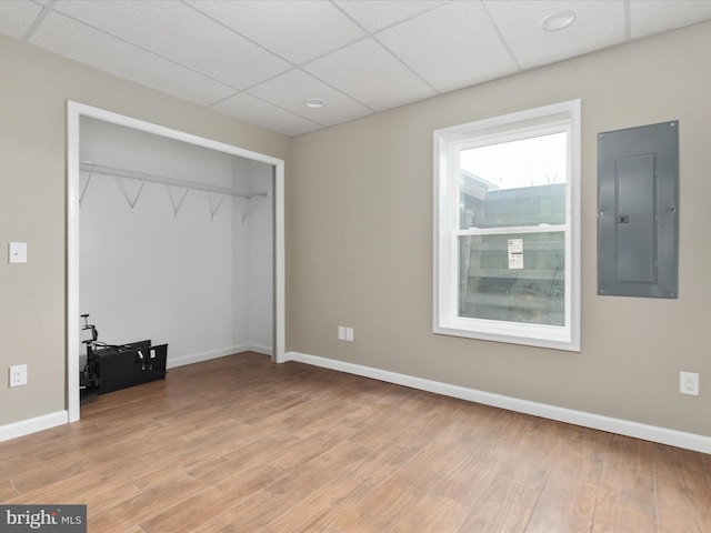 4437 Stonewall Jackson Hwy, Bentonville, VA 22610 - unfurnished bedroom with electric panel, baseboards, light wood-style floors, and a closet