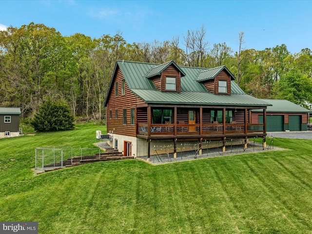 4437 Stonewall Jackson Hwy, Bentonville, VA 22610 - rear view of house with metal roof, a yard, a standing seam roof, an outdoor structure, and a garage