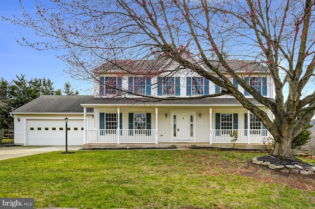 view of front of home with an attached garage, a porch, a front lawn, and driveway