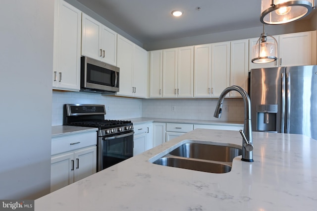 543 Leftwich Ln, Annapolis, MD 21401 - kitchen featuring stainless steel appliances, a sink, white cabinetry, pendant lighting, and light stone counters