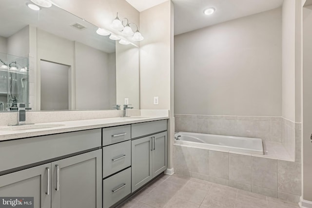 543 Leftwich Ln, Annapolis, MD 21401 - full bathroom featuring tile patterned flooring, double vanity, a bath, and a shower stall